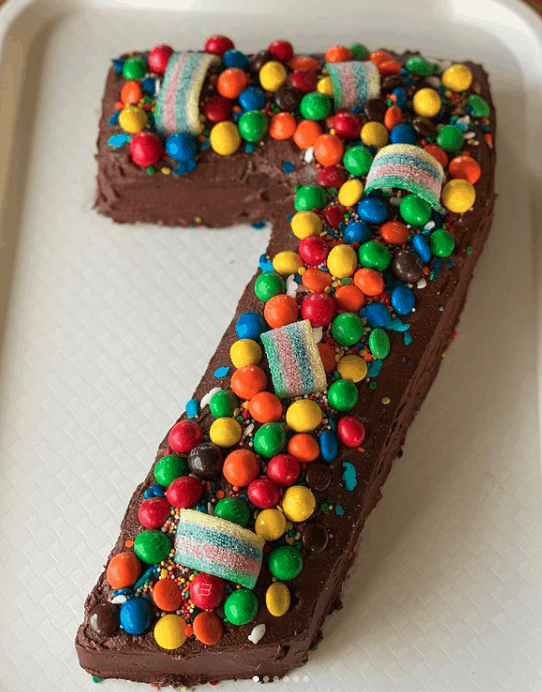 A number 7 chocolate cake decorated with lollies