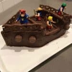 A chocolate pirate cake decorated with pirate figurines.