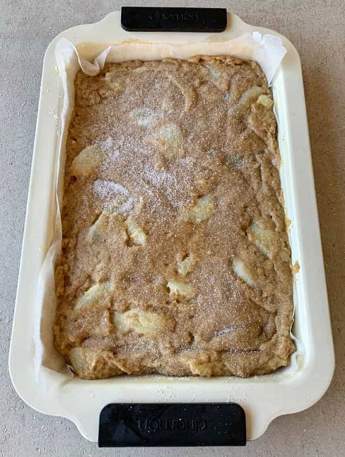 Uncooked Easy Apple Slice in a baking tray on a grey bench.