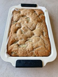 Cooked Easy Apple Slice in a slice tray on a grey bench.