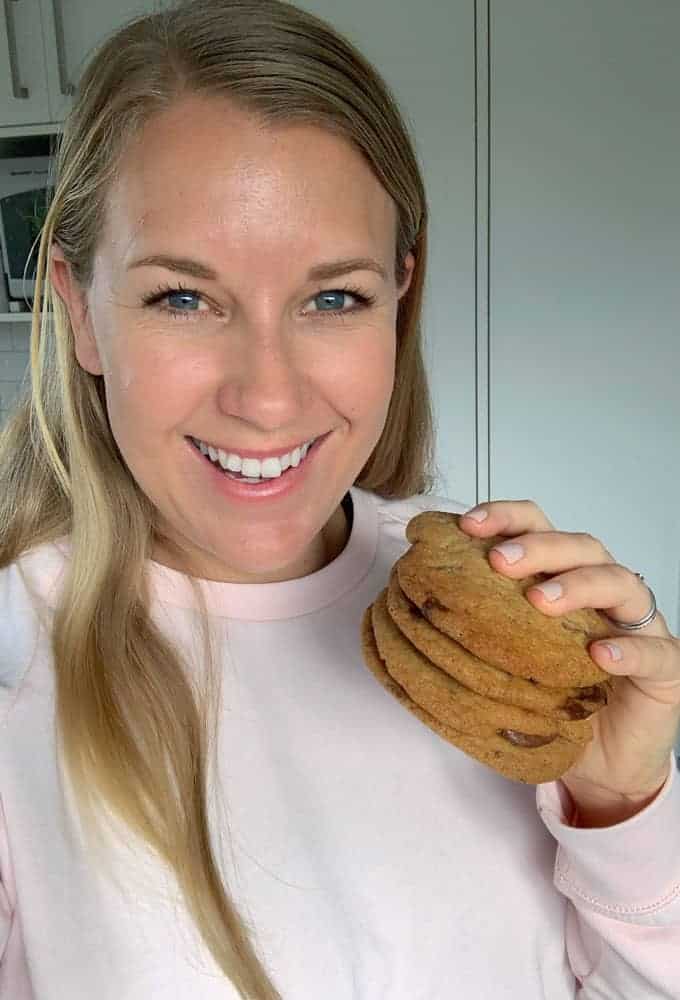 Vanya from VJ cooks holding onto chocolate chunk cookies 