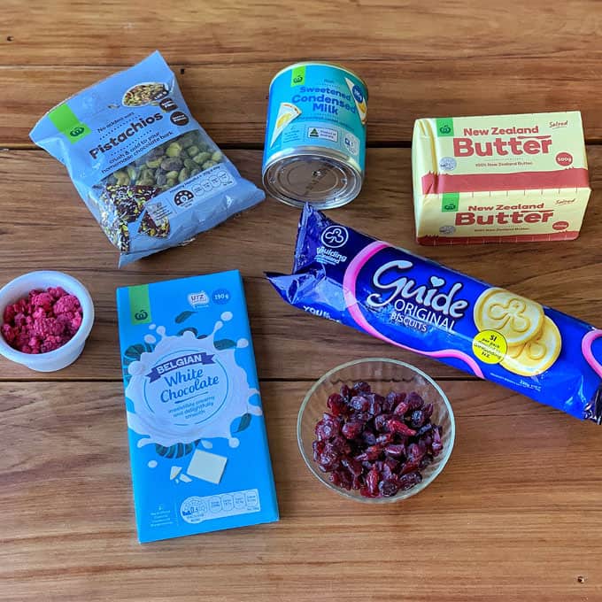 The ingredients for Cranberry and pistachio slice on a wooden bench.