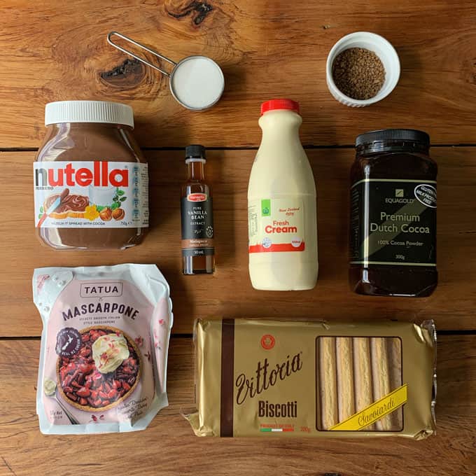 The ingredients for Nutellamisu sitting on a wooden bench 