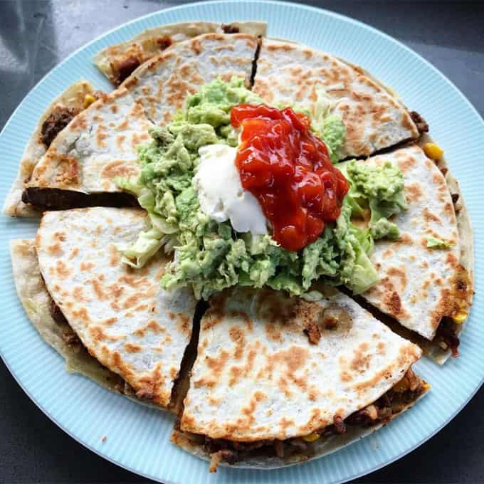 Mexican chicken and rice in quesadilla with guacamole and salsa