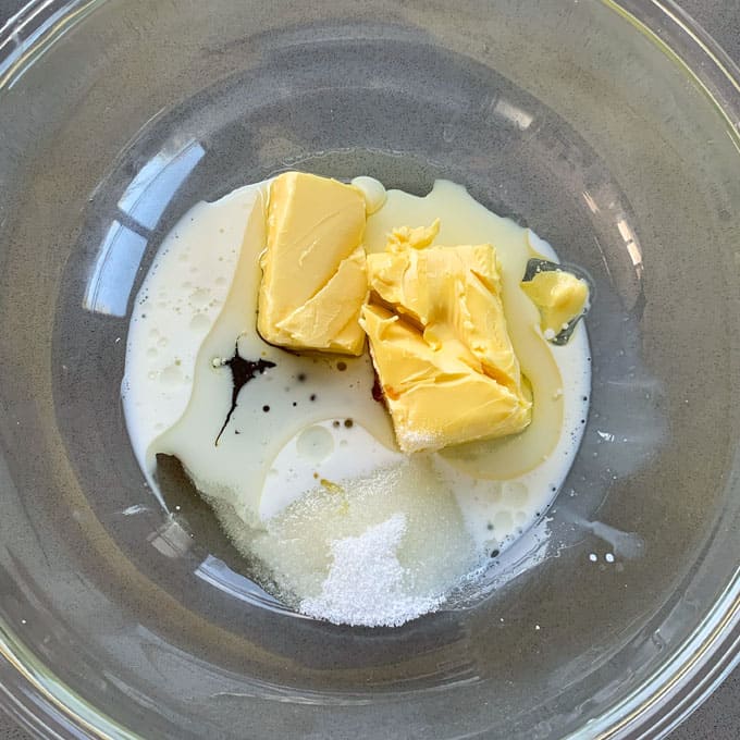 Butter, milk and vanilla in the base of a glass bowl.