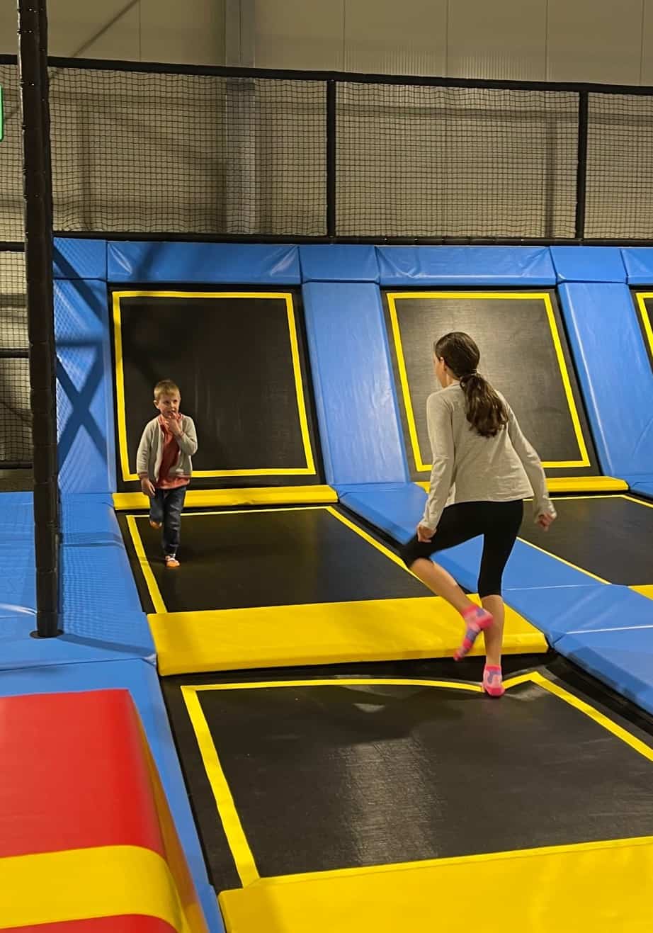 A boy and girl at a trampoline park