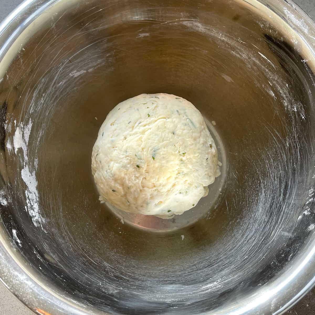 Scone dough in a stainless steel bowl.