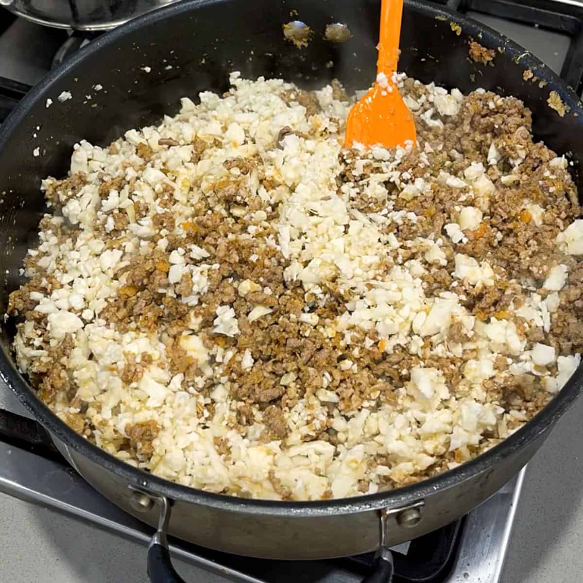 Mince and cauliflower cooking a fry pan.