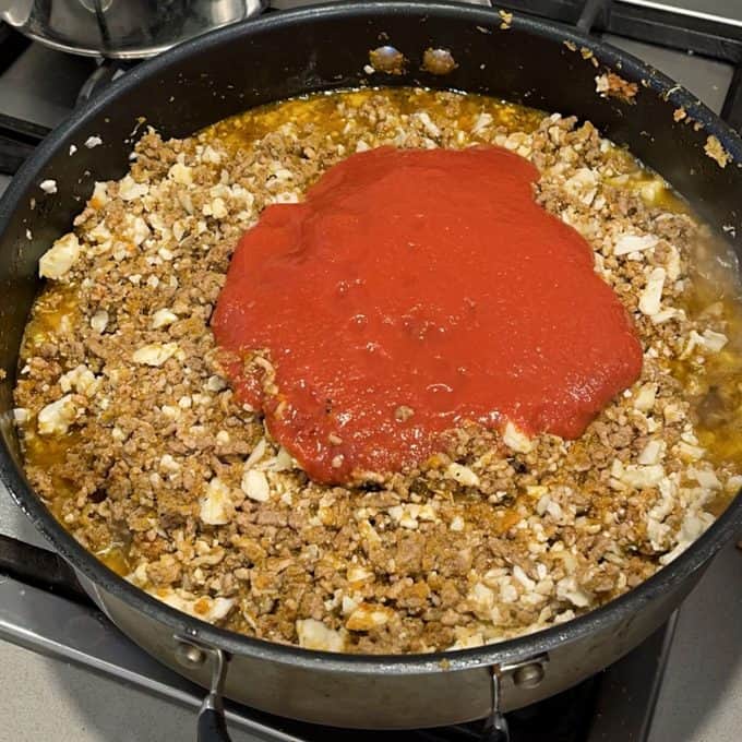 Vanya's Lasagne Mince and crushed tomatoes in a frying pan
