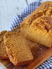 Sliced gingerbread loaf on a wooden board.