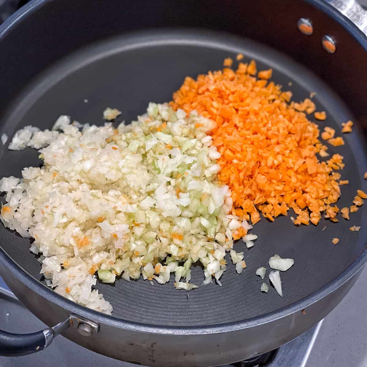 Diced vegetables cooking in a pan