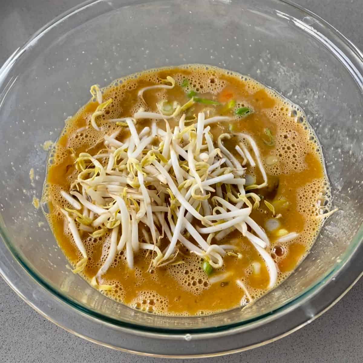 Eggs, spices and bean sprouts in a glass bowl