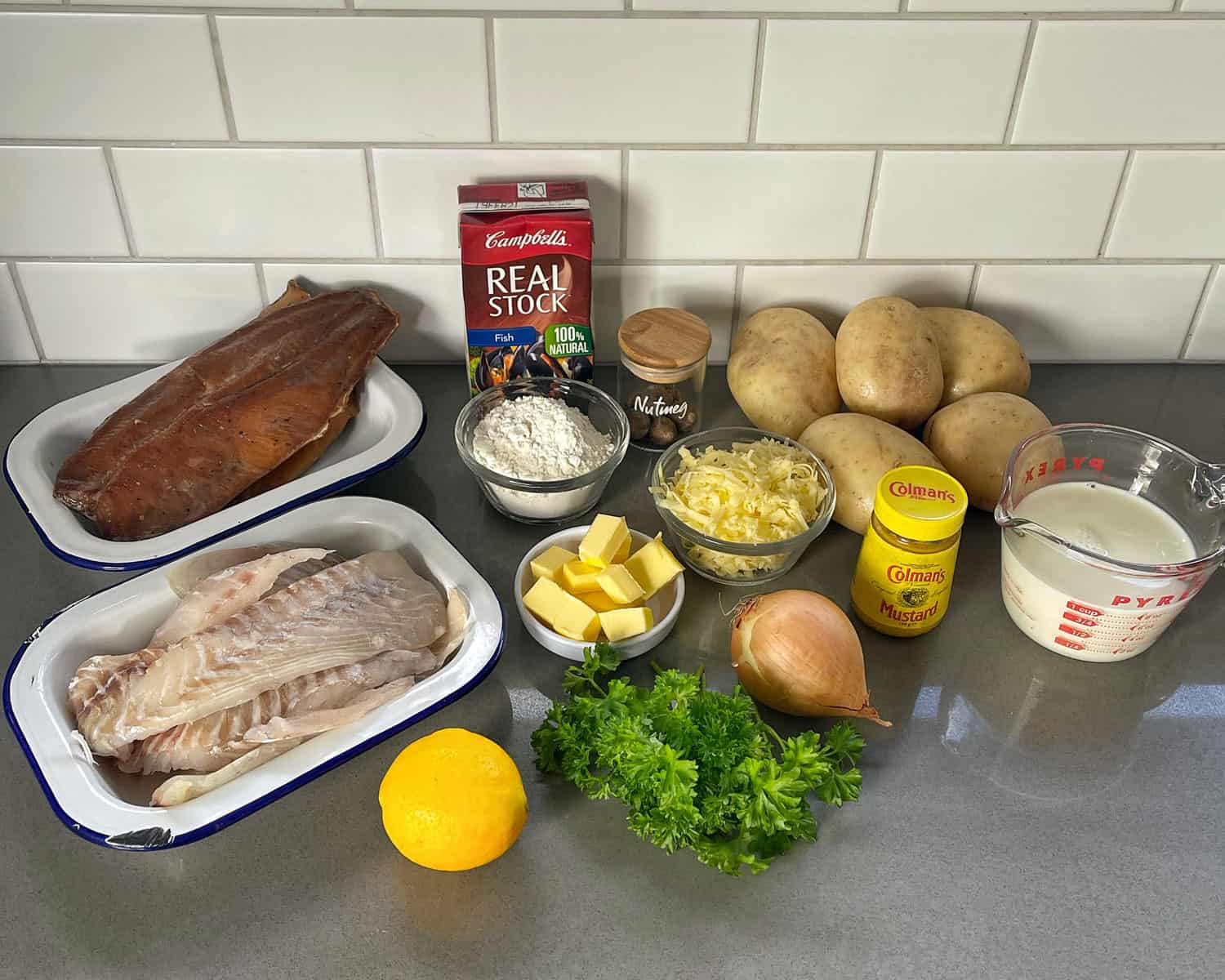 Ingredients for Smoked Fish pie on a grey bench
