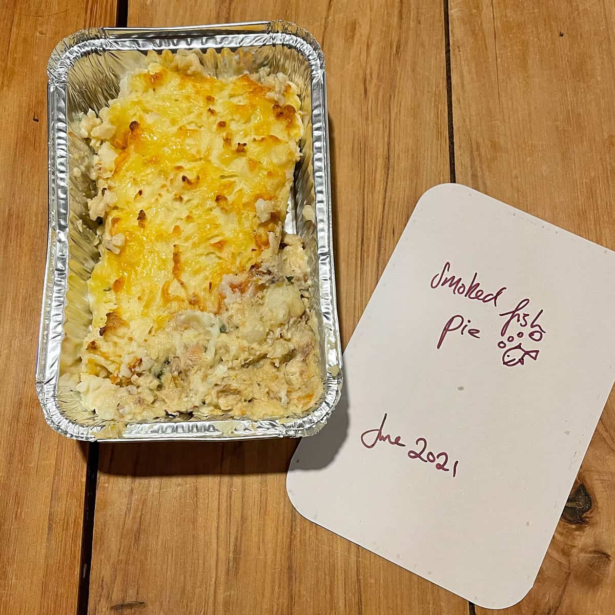 Leftover smoked fish pie in a foil tray for the freezer.