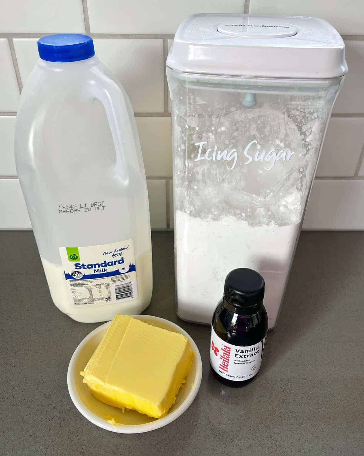 Ingredients for Buttercream icing on a grey bench.