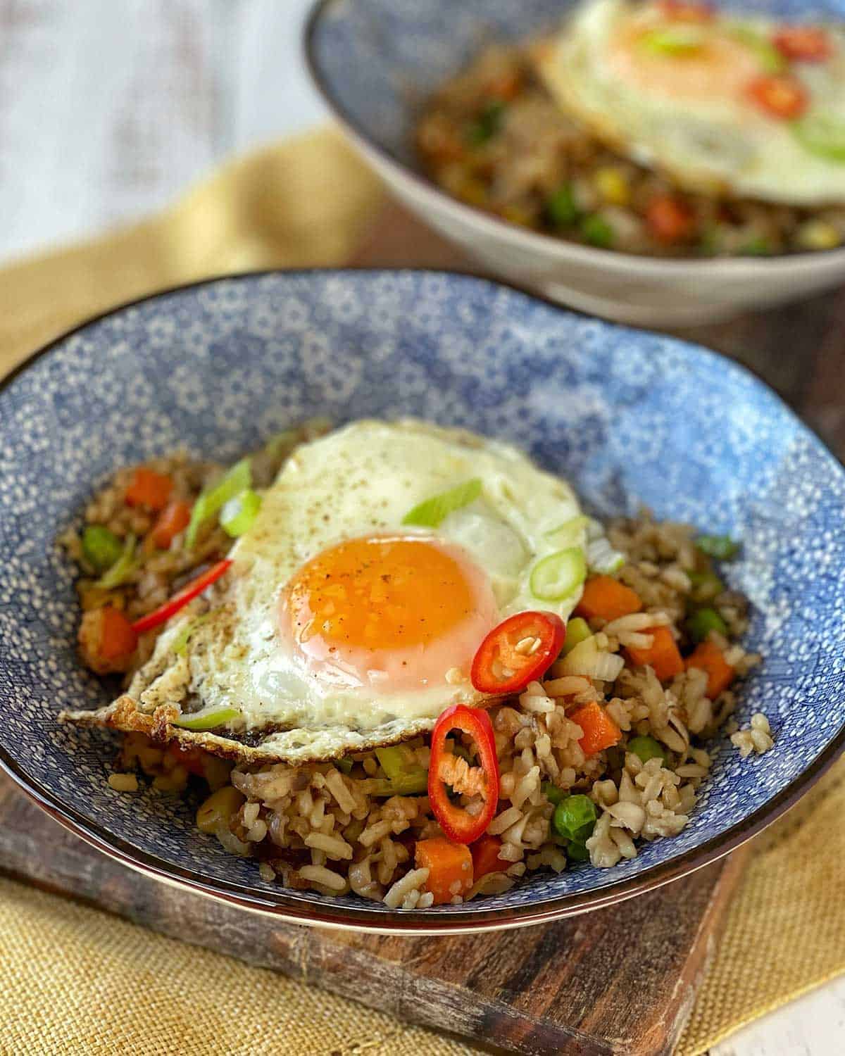 Mushroom Fried Rice in a blue bowl on a wooden board