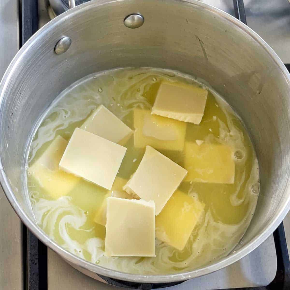 Butter and white chocolate melting in a saucepan