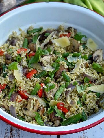 A close up of Mushroom and brown rice salad in a white bowl.