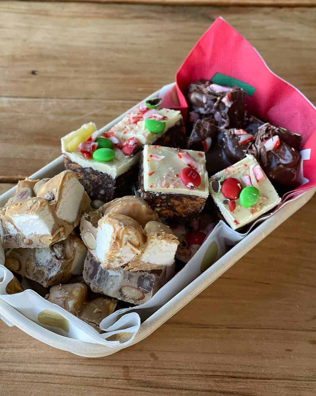 Christmas treats in a small container on a wooden bench