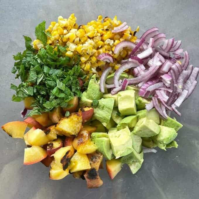 Grilled Pork, Peach and Corn Salad All the chopped salad ingredients in a glass bowl together.