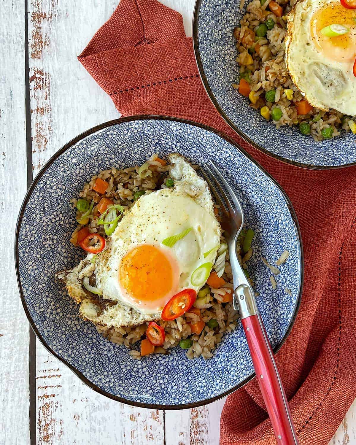 A bowl of Mushroom Fried Rice with a Fried Egg on top.