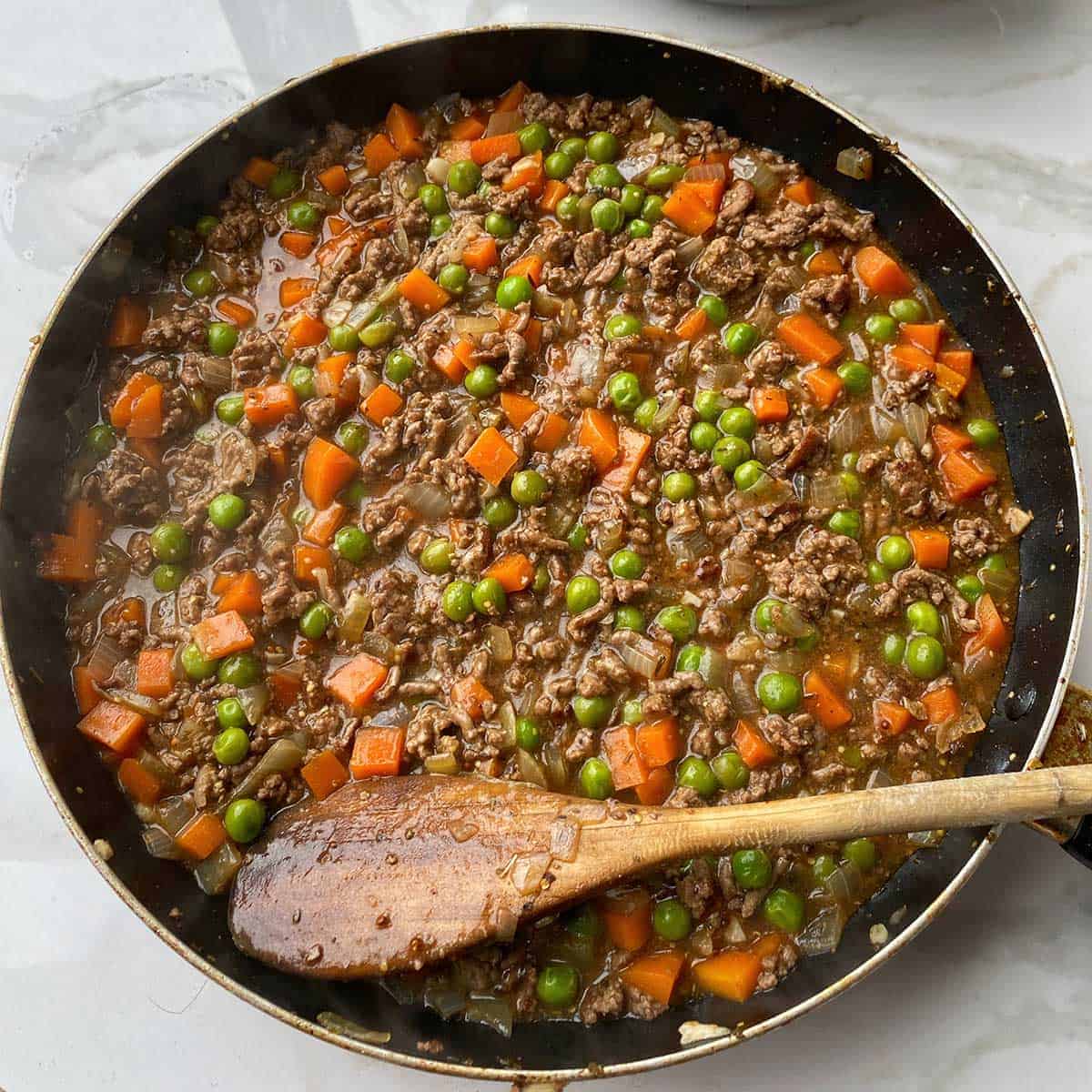 Cooked mince and vegetables in a pan.