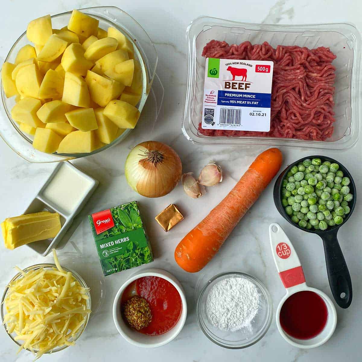 The ingredients for Beef Cottage Pies sitting on a white bench.