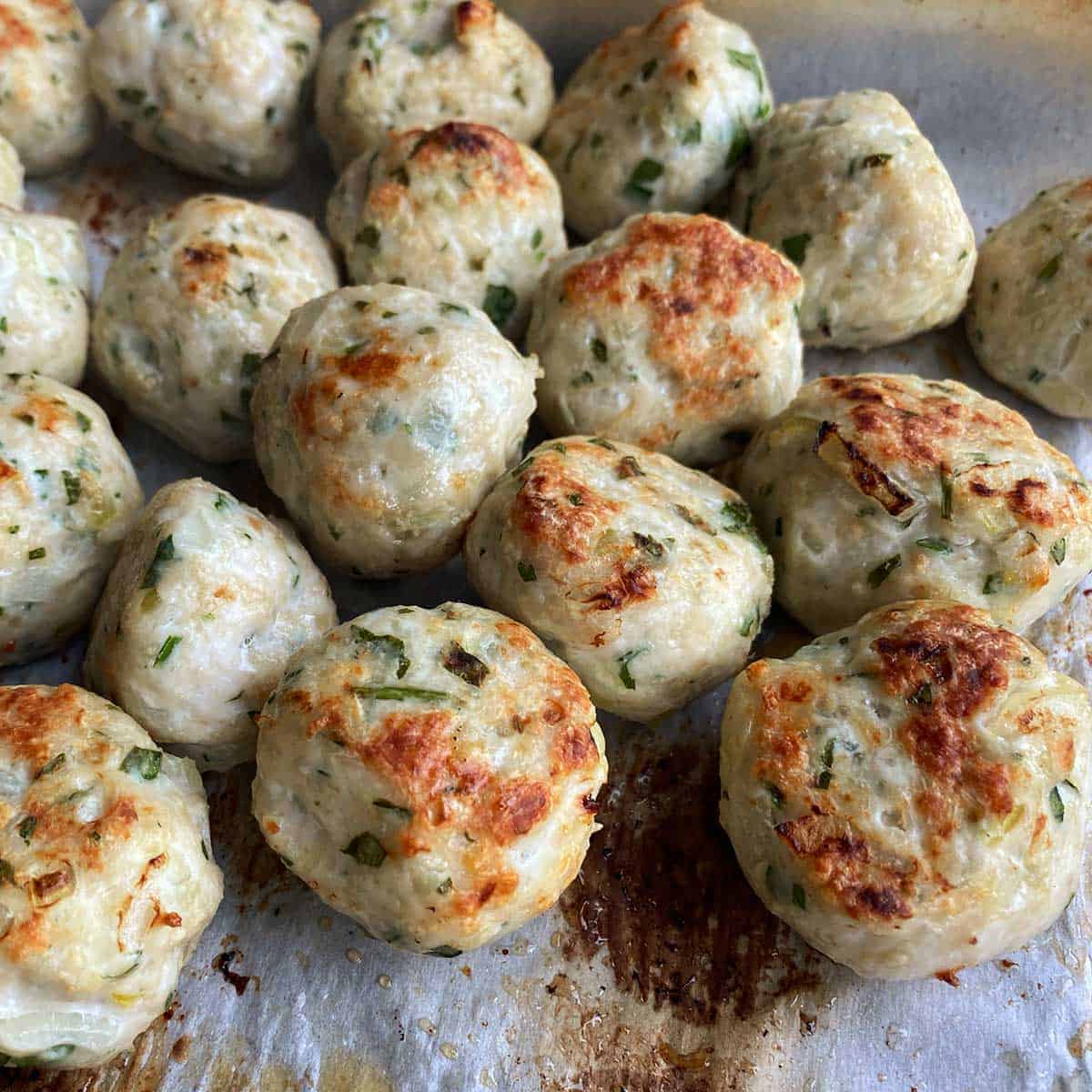Grilled chicken meatballs on a baking tray