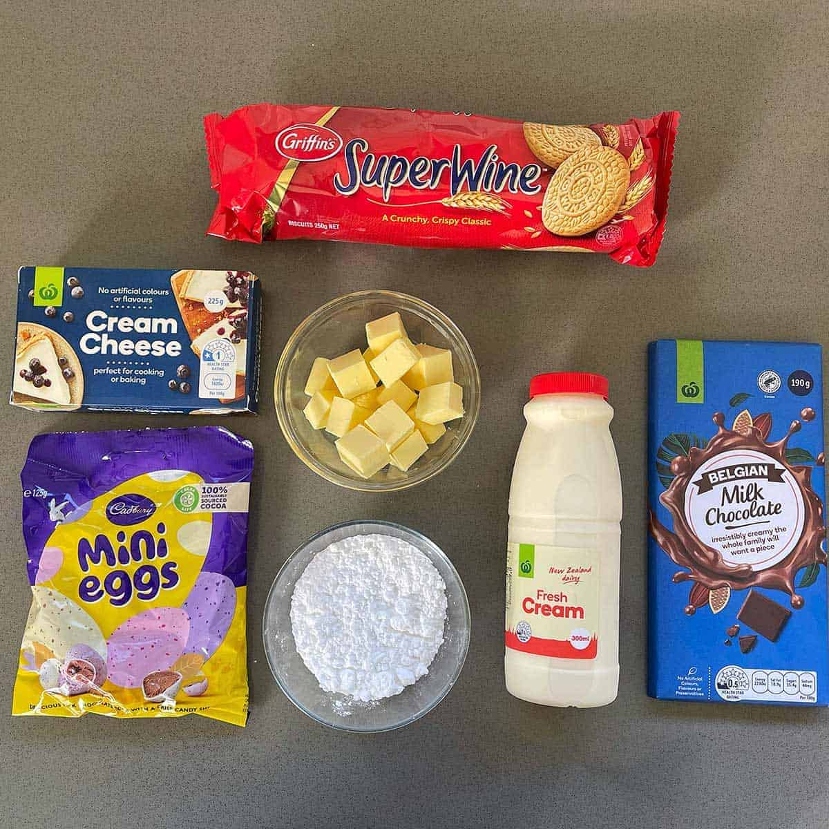 The ingredients for Easter Cheesecake Cups sitting on a grey bench.