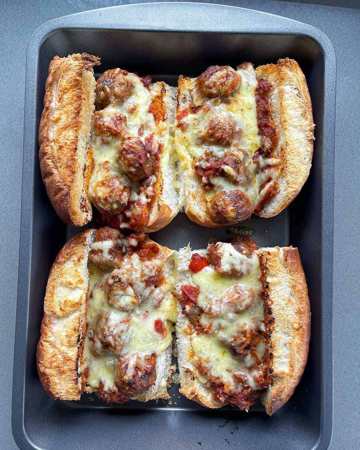 Cooked Meatball subs on a baking tray