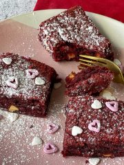 3 pieces of red velvet brownie on a pink plate.
