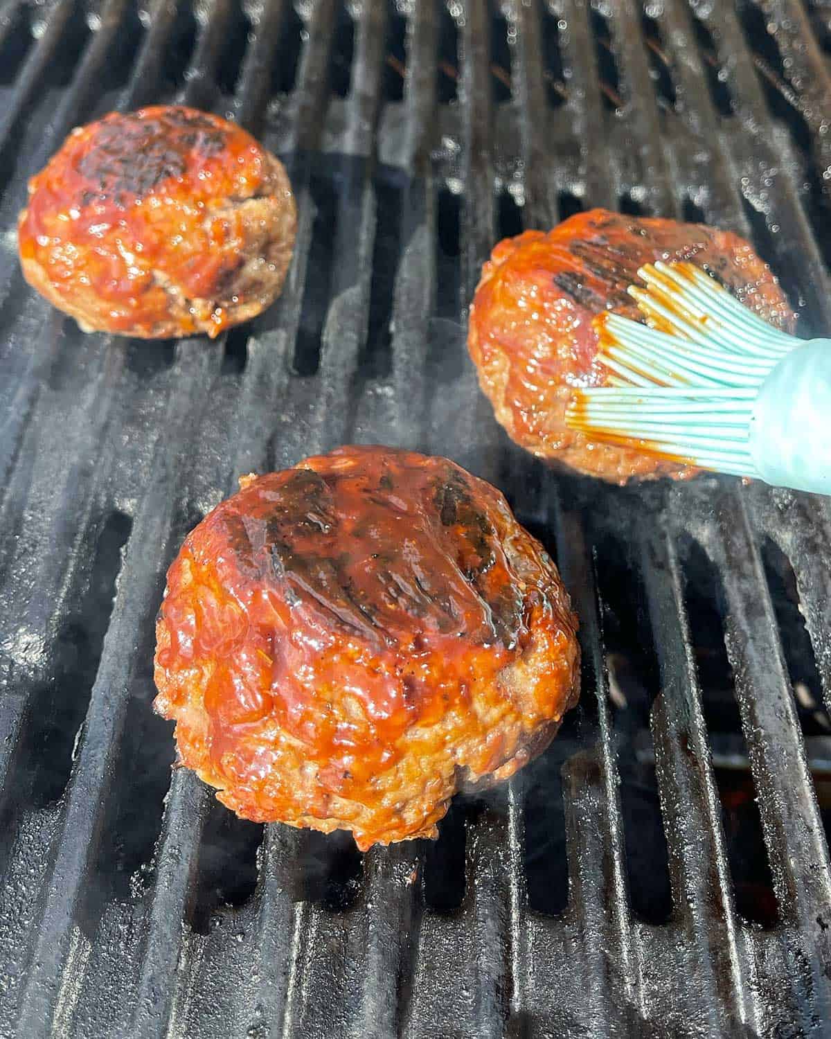 Beef Rissoles cooking on a BBQ