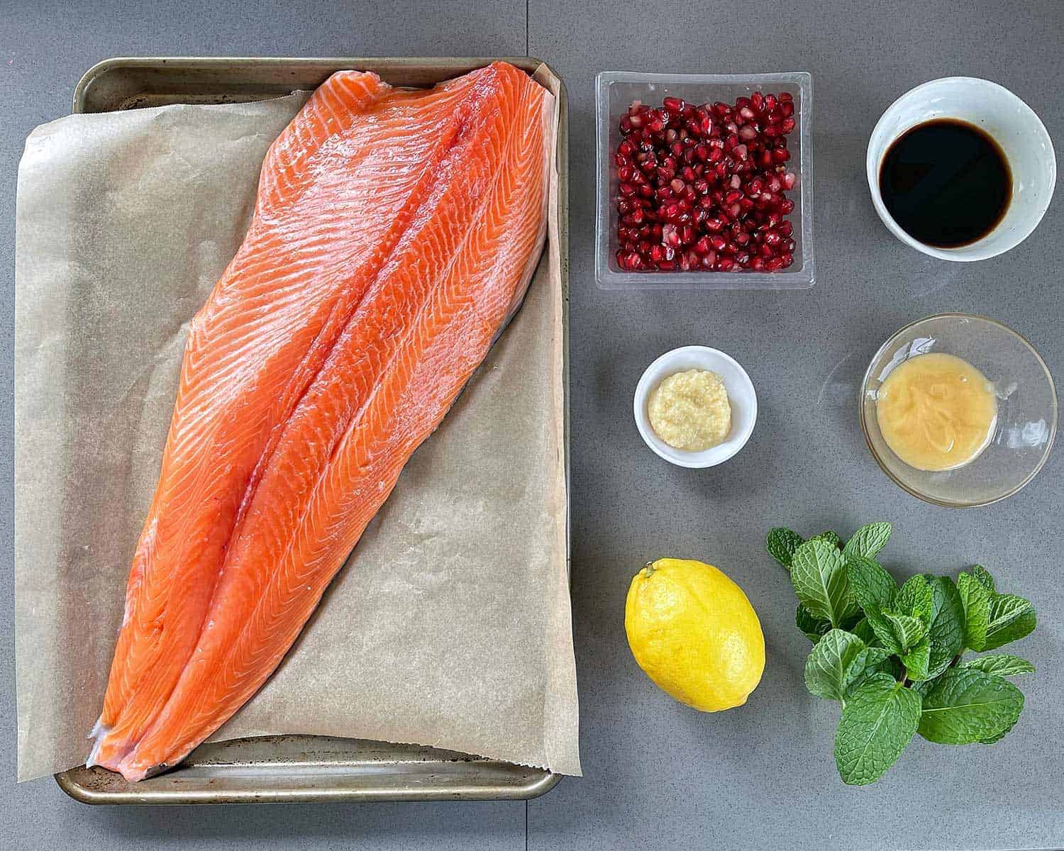 The ingredients for Whole Baked Salmon on a grey bench.