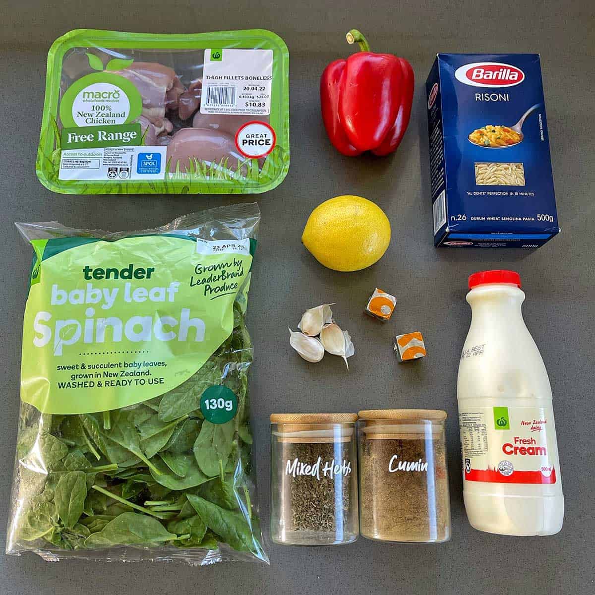 The ingredients for Lemon Orzo Chicken on a grey bench.