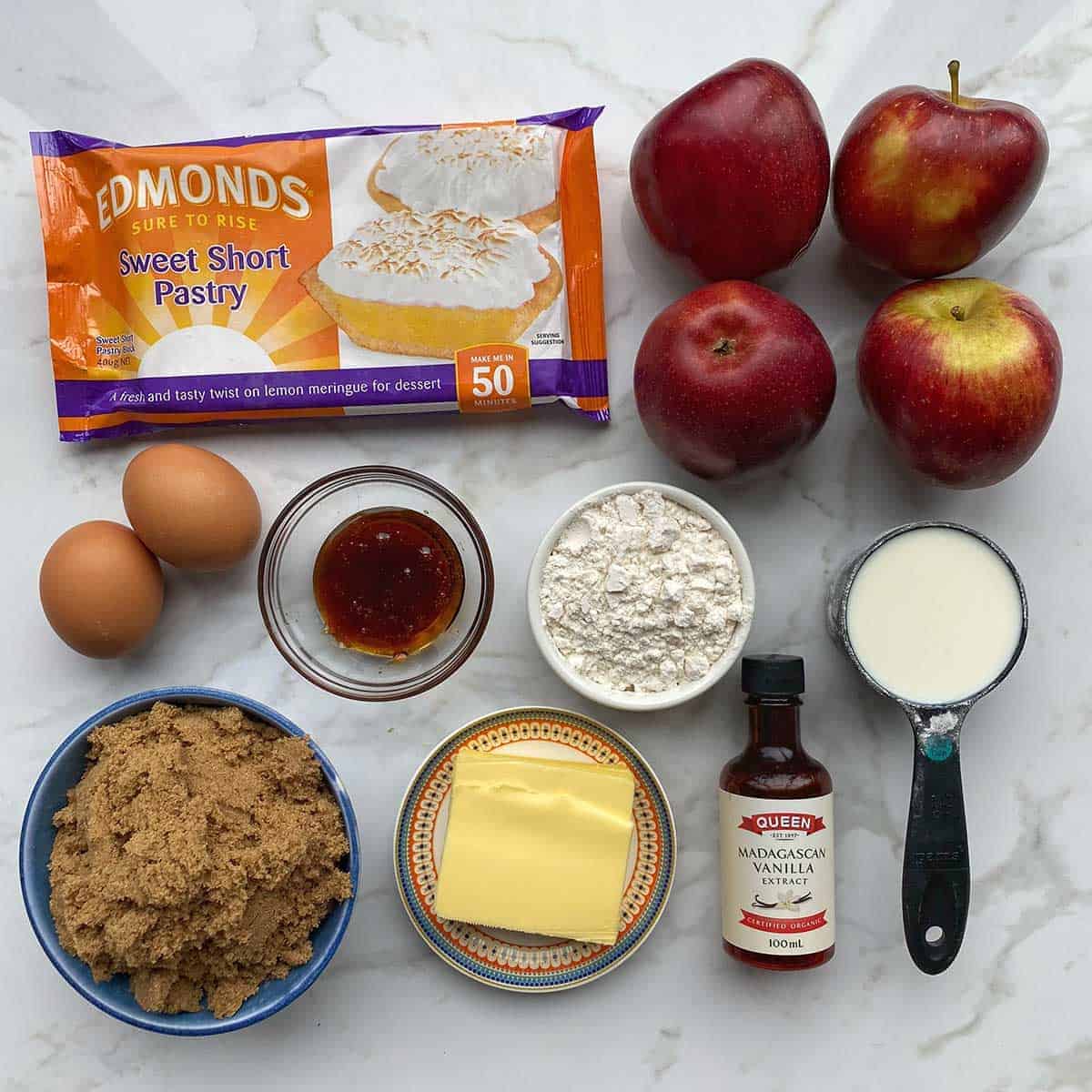 The ingredients for Salted Caramel Apple Tart on a grey bench
