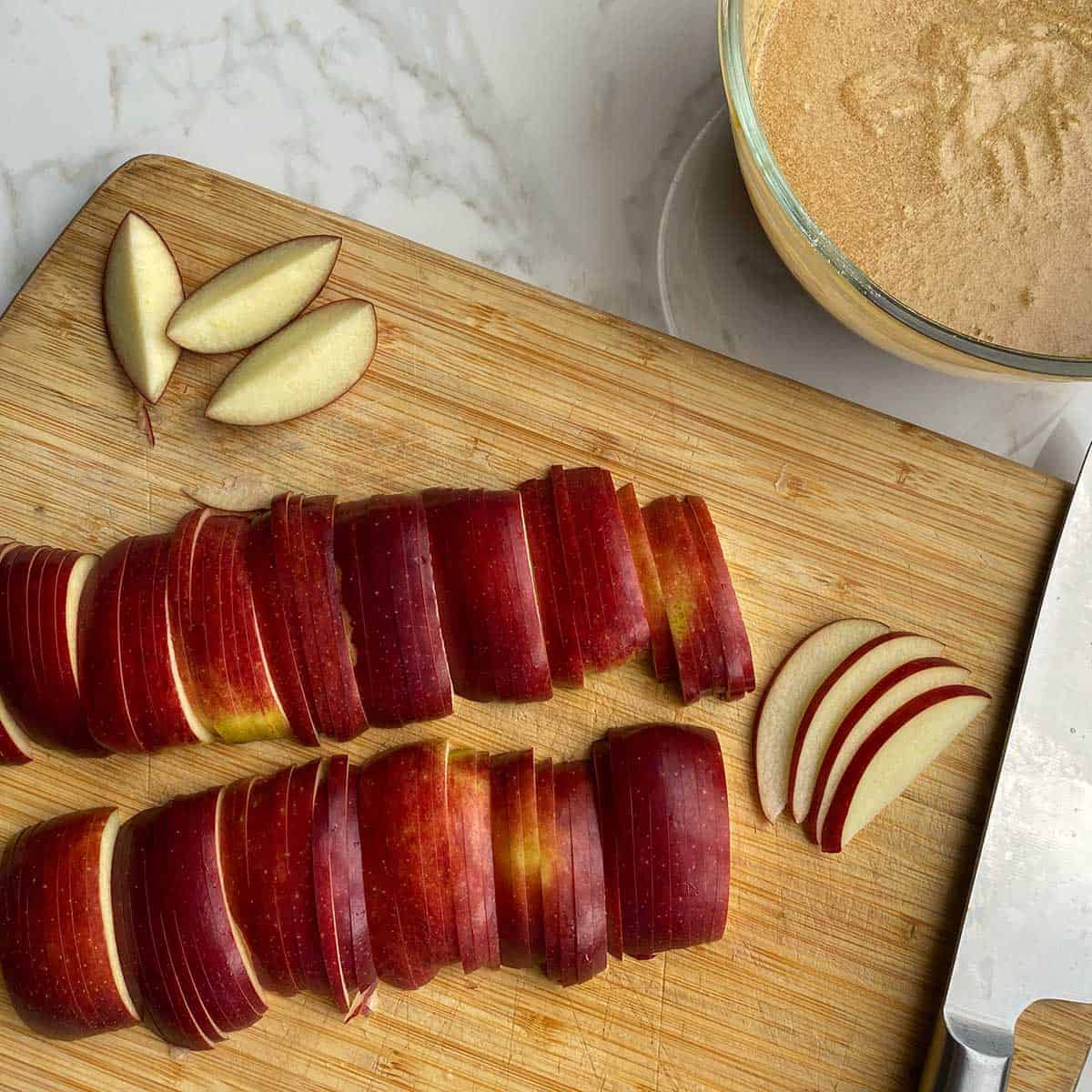 Sliced apples on a wooden chopping board