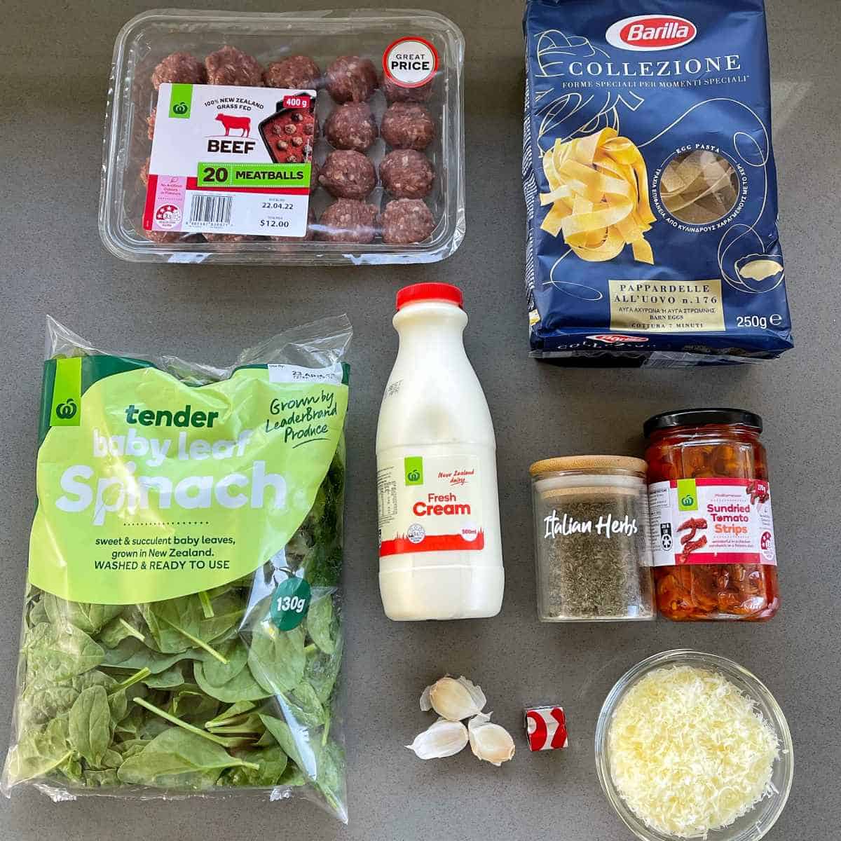 The ingredients to make Tuscan meatballs and pasta on a grey bench
