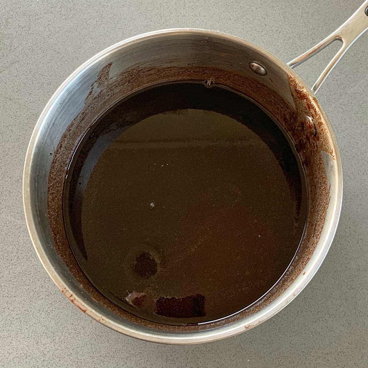 Melted chocolate in the bottom of a saucepan.