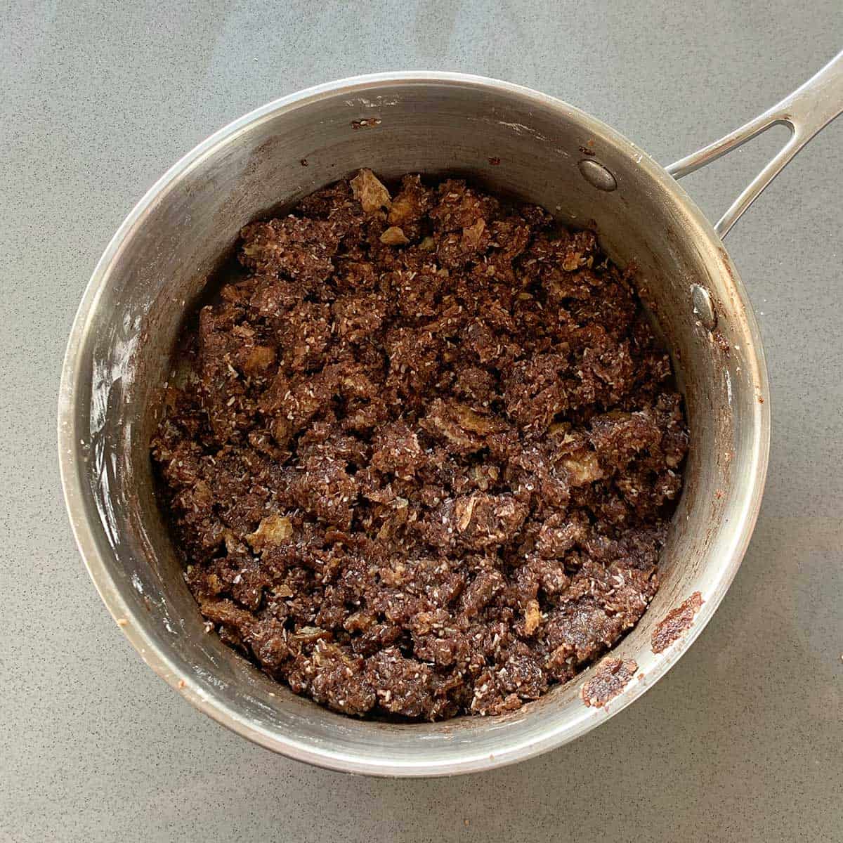 The base of Chocolate Weetbix Slice mixed together in a saucepan.