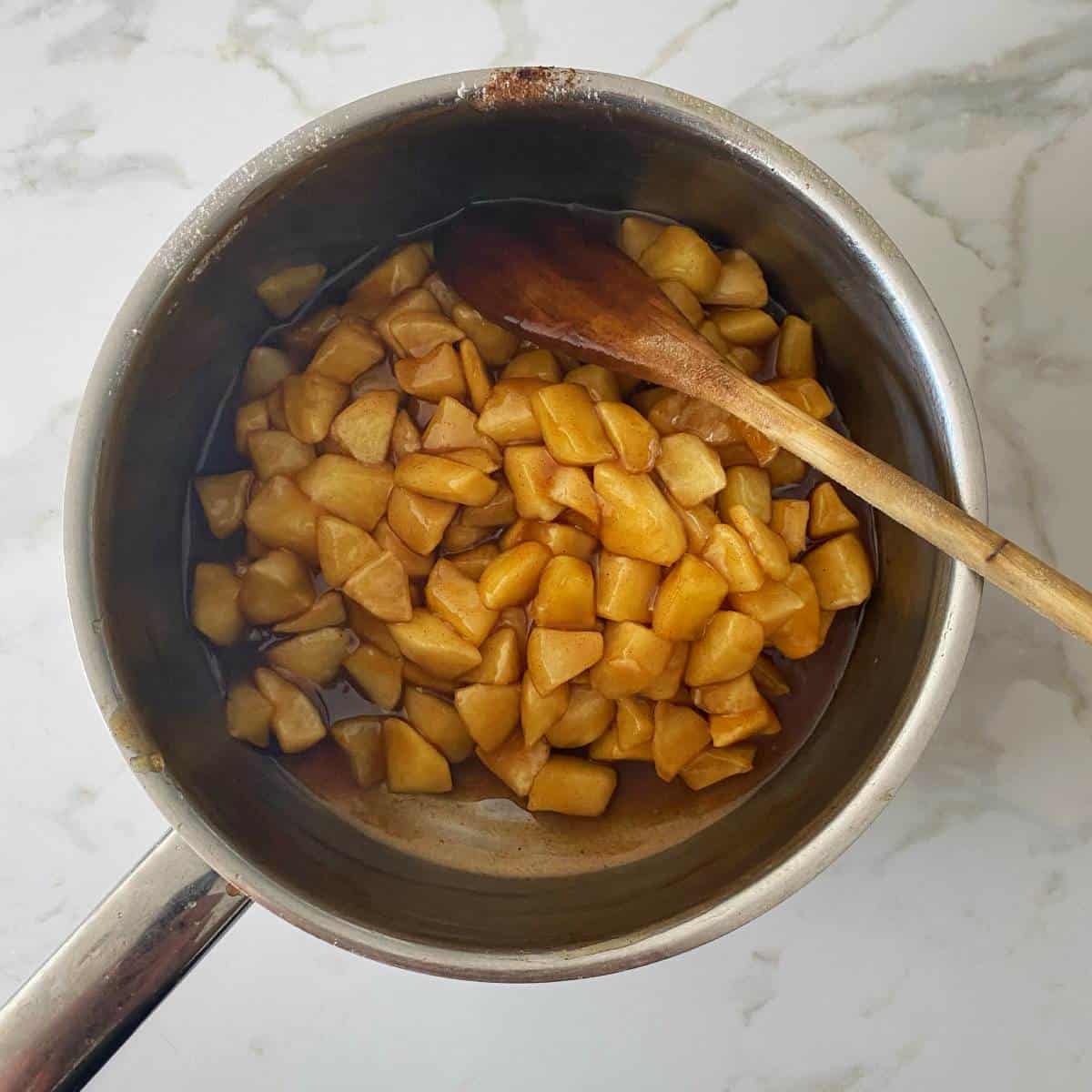 Diced apples and sugar syrup in a pot