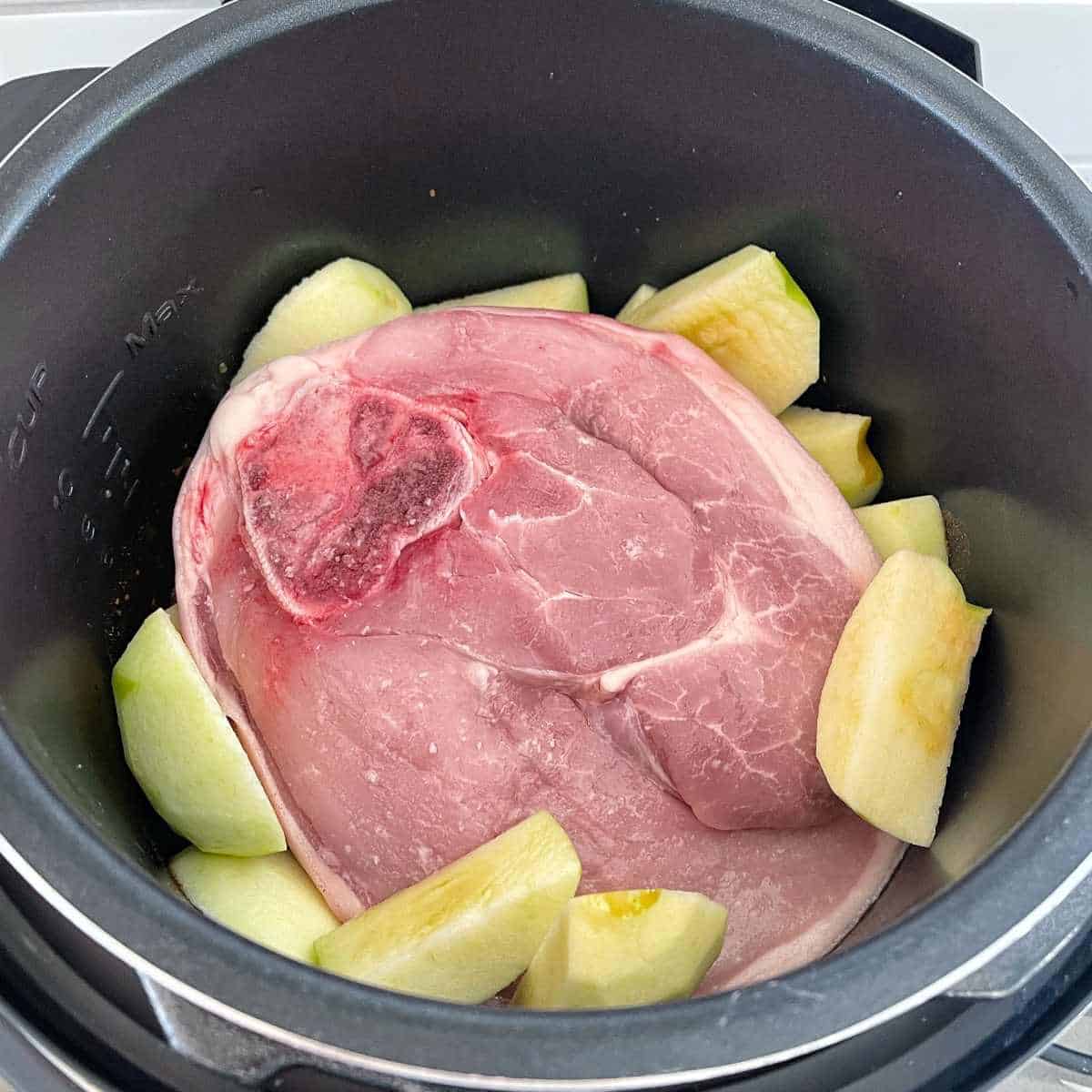 Ingredients for pulled pork and apple pie sitting inside the pressure cooker
