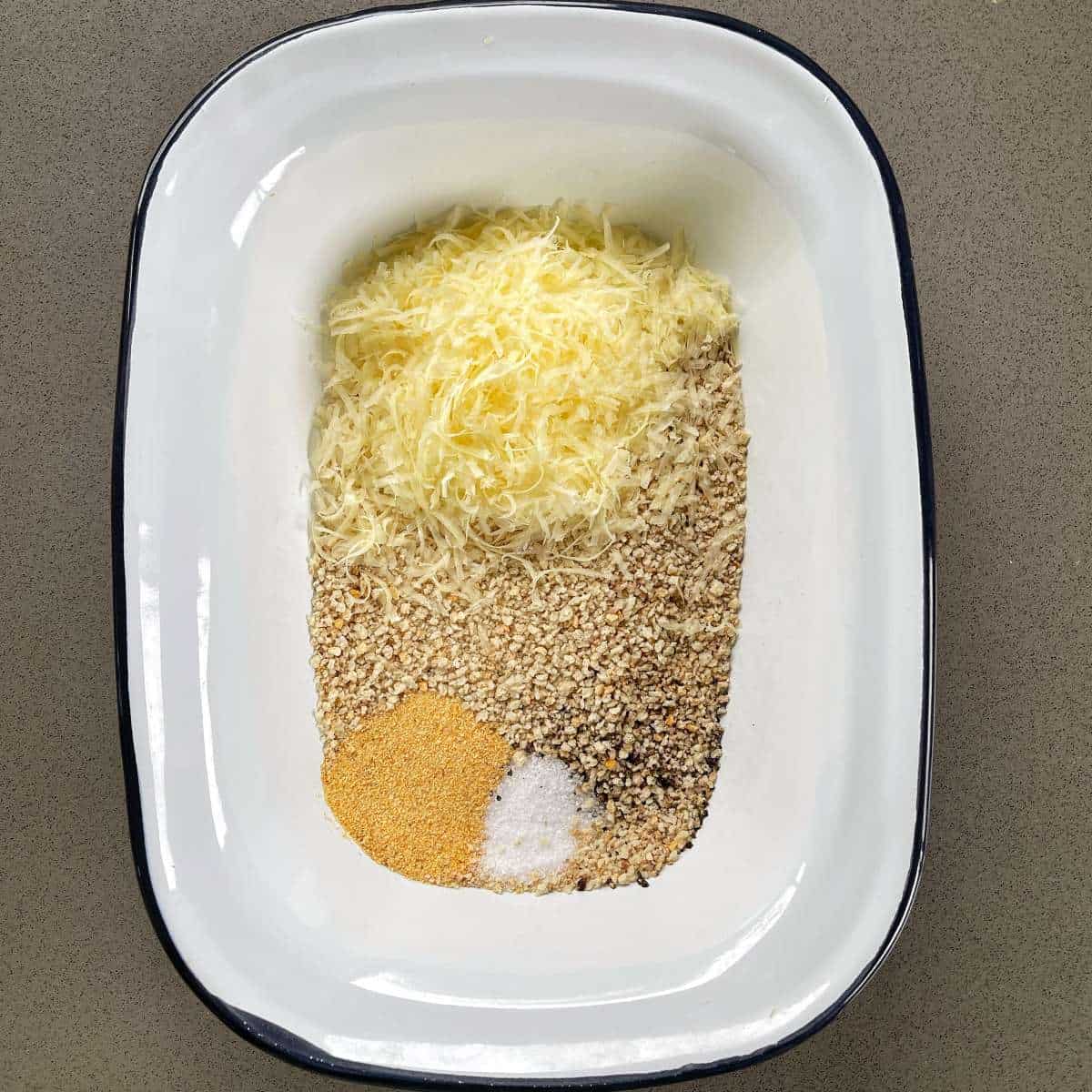 Dry ingredients in a white dish to use to crumb the chicken breast