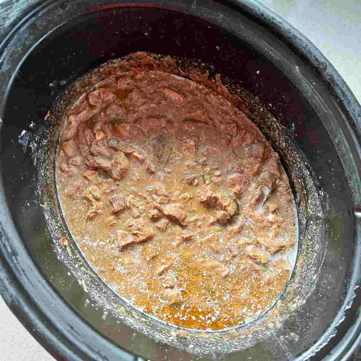 Cooked lamb and mint pie mixture in a slow cooker