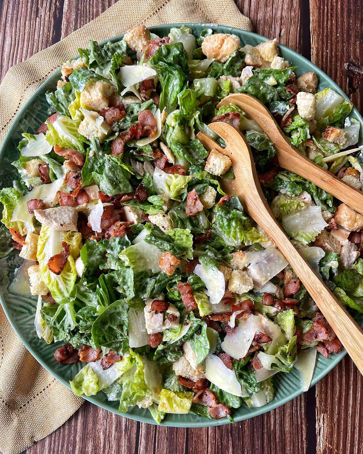 A large salad bowl with chicken caesar salad.