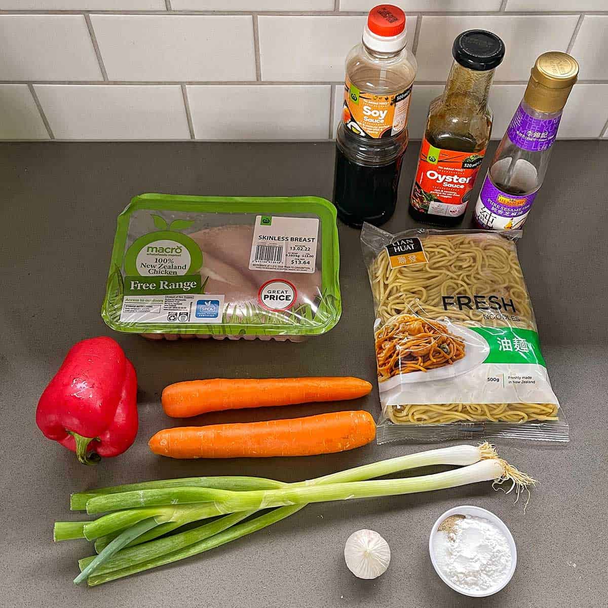 the ingredients for chicken Chow Mein on a grey bench