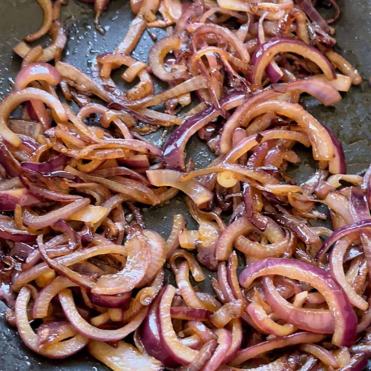 Fried red onion in frypan