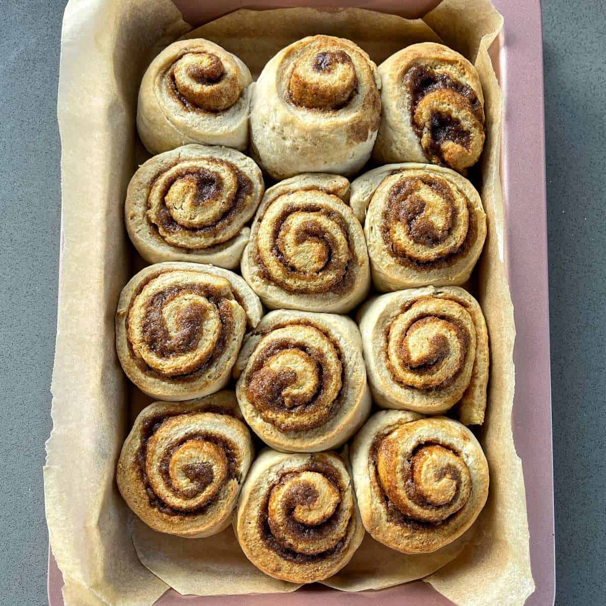 12 baked cinnamon pinwheels in a oven dish