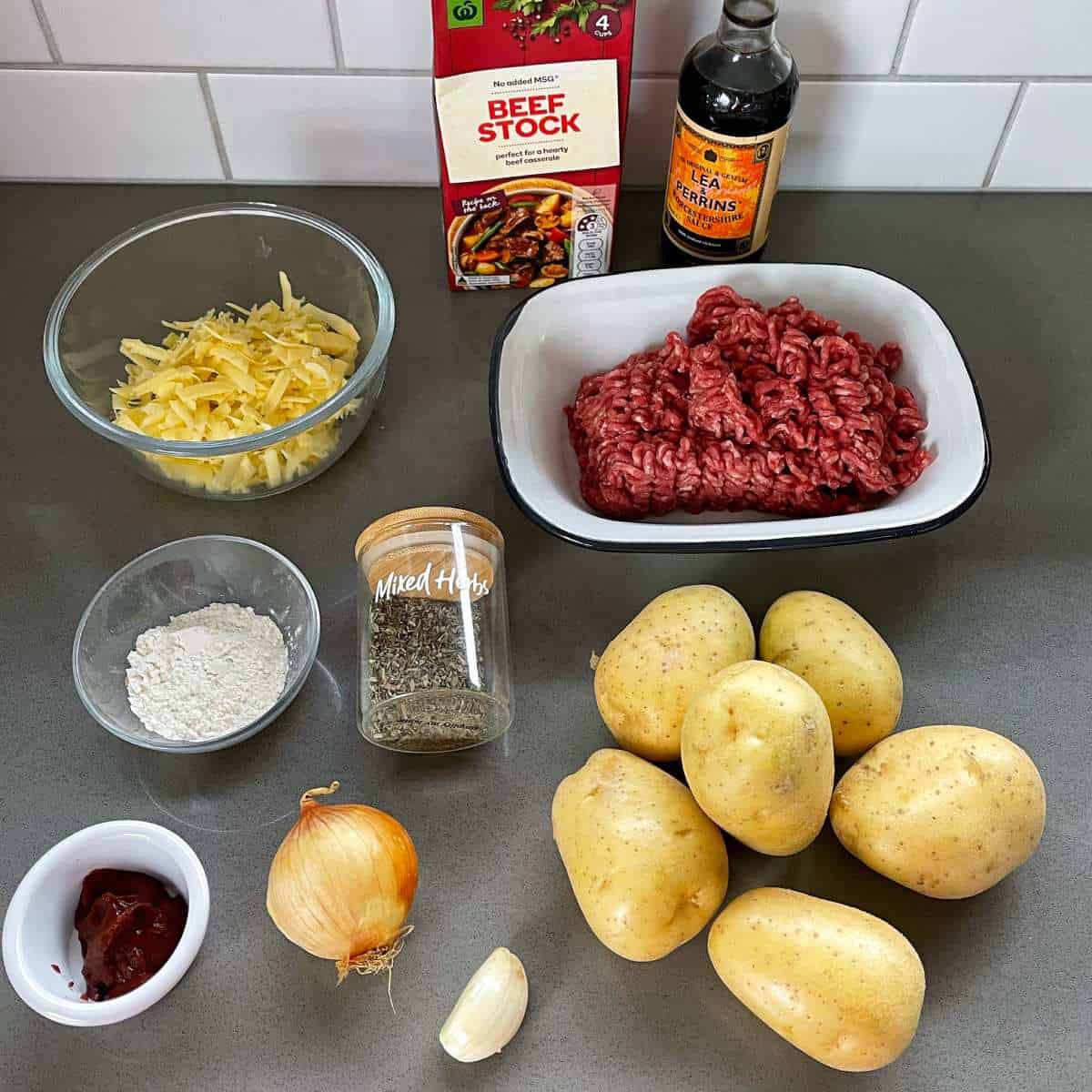 Ingredients for potato top pie sitting on a grey bench