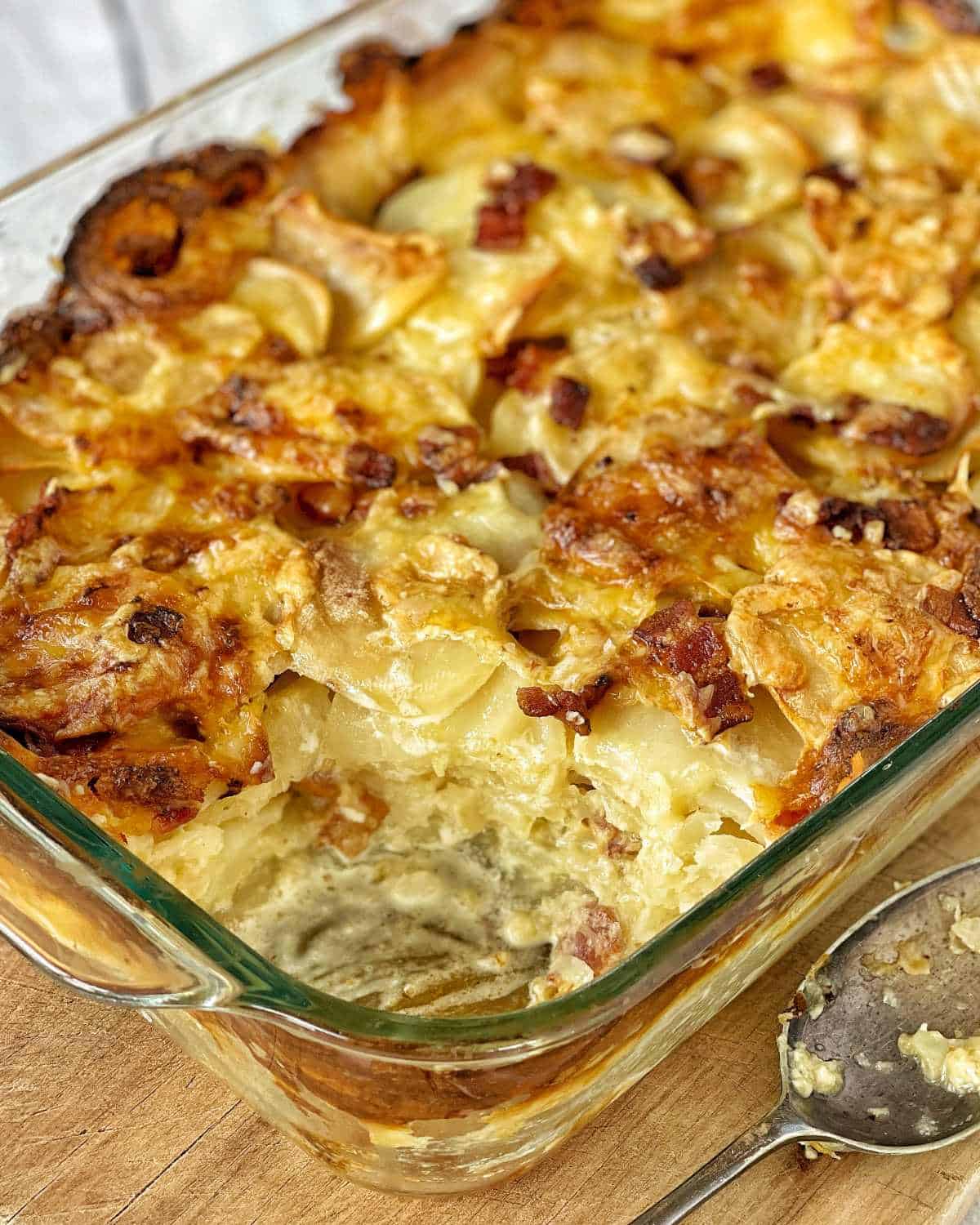 Cooked bacon and potato bake with a slice removed from the corner