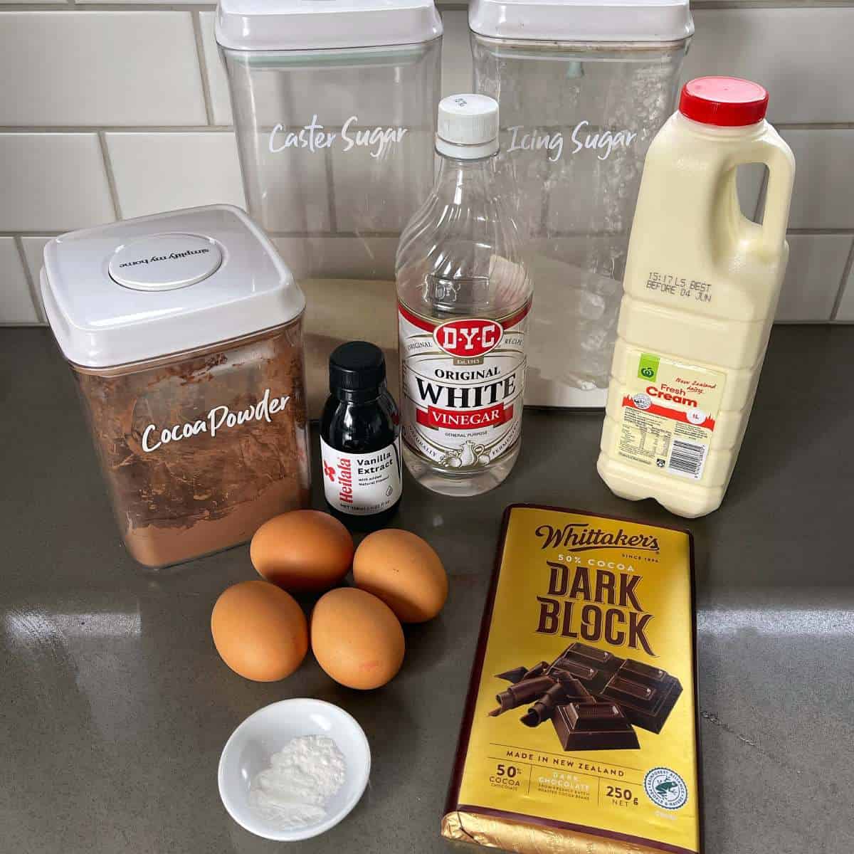 The ingredients for chocolate pavlova sitting on a grey bench top